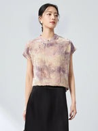 Front view of a women's New Chinese Style top in champagne, with a stand collar, delicate frog buttons, and an intricate jacquard/flocking pattern.