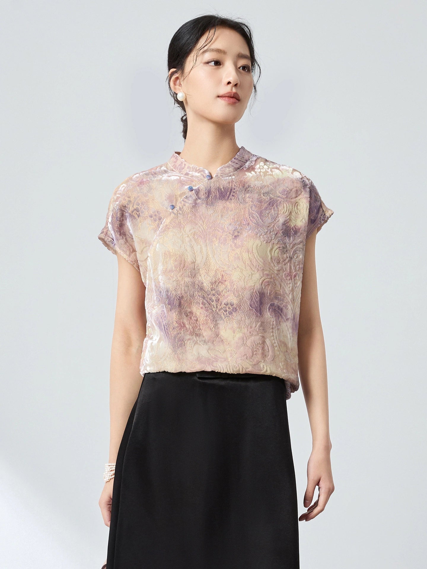 Front view of a women's New Chinese Style top in champagne, with a stand collar, delicate frog buttons, and an intricate jacquard/flocking pattern.