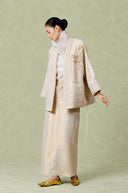 Side view of the champagne beige linen jacket and matching long skirt