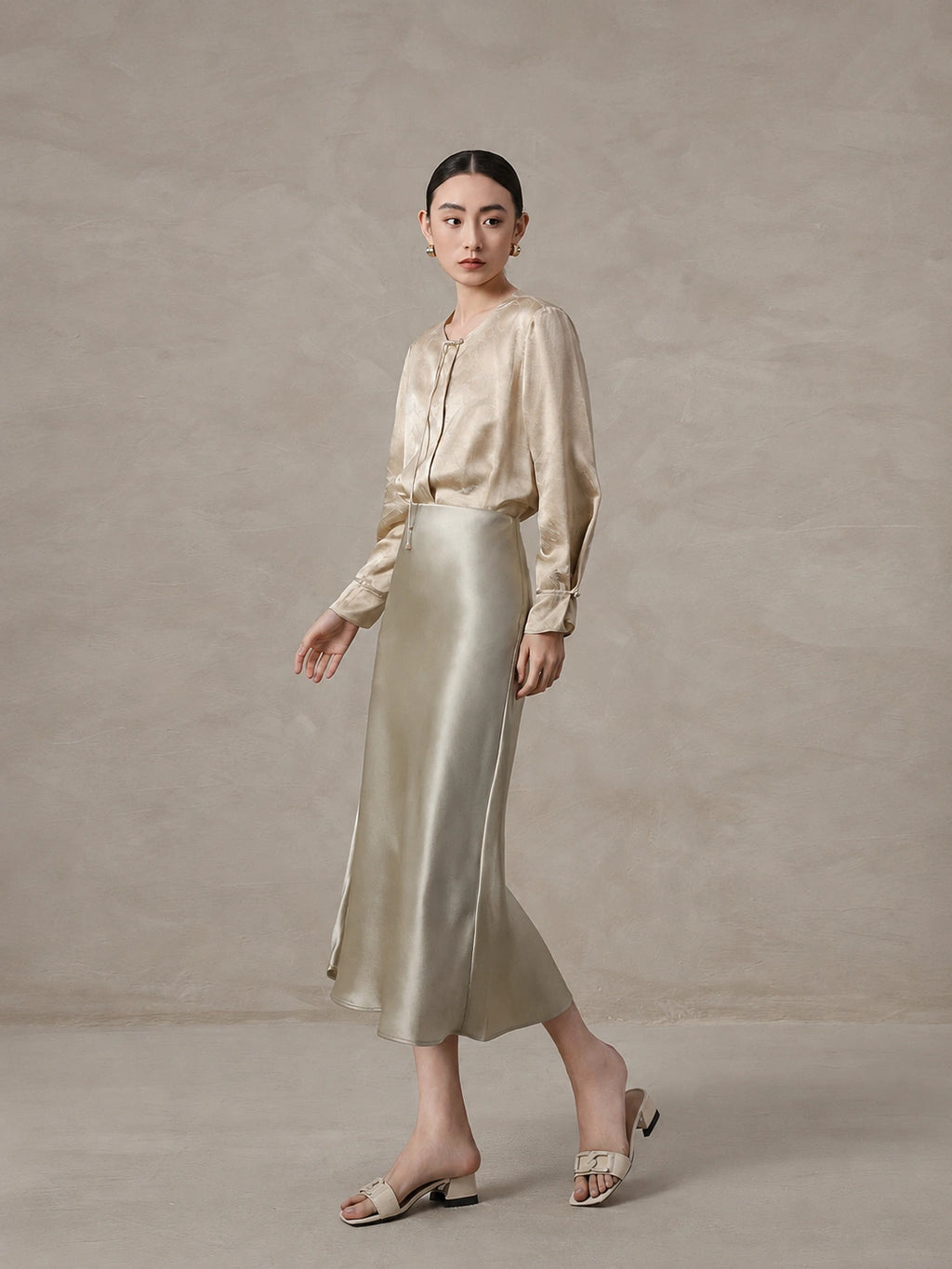 Elegant champagne mulberry silk blend blouse styled with a satin skirt
