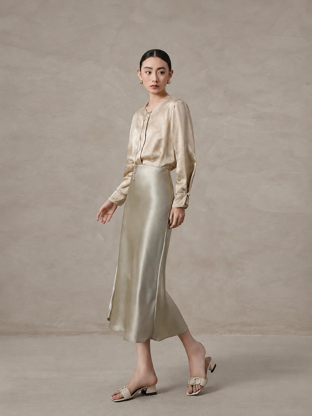Elegant champagne mulberry silk blend blouse styled with a satin skirt