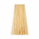 Flat lay of a champagne pleated maxi skirt with an elastic waistband and full length, crafted from 80% Lyocell, 20% Polyester.