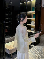 Back view of a Champagne Sage pure silk cardigan showcasing its lightweight drape and semi-transparent silk fabric.