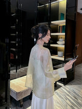 Back view of a Champagne Sage pure silk cardigan showcasing its lightweight drape and semi-transparent silk fabric.