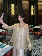 Front view of a Champagne Sage pure silk sheer cardigan featuring traditional frog-button closures and a flowing fit.
