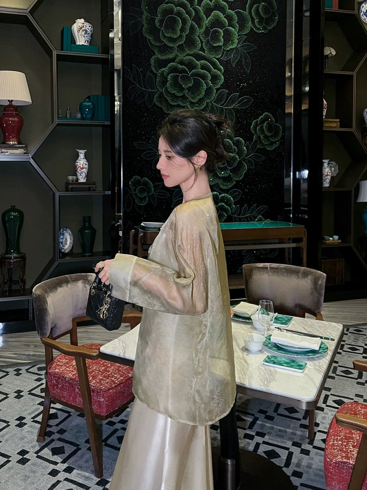 Woman wearing a lightweight Champagne Sage silk cardigan with a relaxed silhouette in an elegant interior.