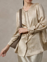 Side detail of a champagne jacquard silk blend blouse