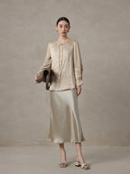 Woman wearing a champagne mulberry silk blend jacquard blouse