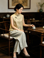 Chinese-inspired champagne yellow silk vest with floral embroidery worn in a traditional tea setting