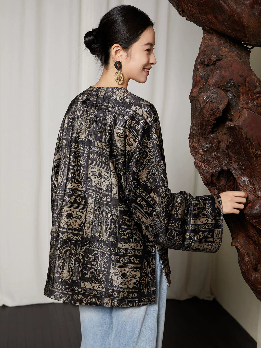 Back view of women's charcoal black jacquard blouse
