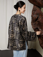 Back view of women's charcoal black jacquard blouse