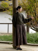 Model showing the blouse’s long sleeve, short shaped hem and off-centre front button details.