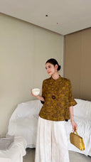 Side view of a women's Qipao top with unique floral brocade, crafted from premium Lyocell, viscose, and wool blend for a soft, refined look.