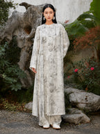 Woman wearing an ivory Chinese ink landscape print maxi dress with long sleeves, round neckline and adjustable side tie waist, front view.