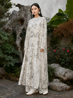 Three-quarter view of a flowing ivory Chinese ink landscape print maxi dress made from a premium viscose and acetate blend.