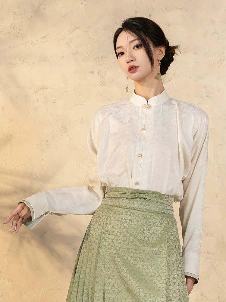 Close-up of a women's Mandarin collar blouse featuring subtle jacquard texture and frog-button detail.
