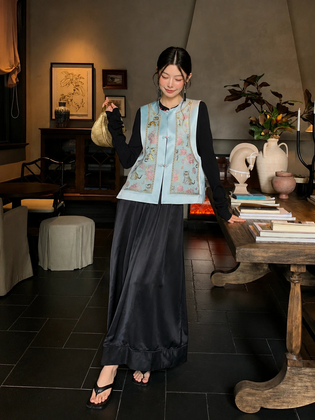 Full-body look featuring a light blue Songjin silk Chinese vest with botanical floral pattern and traditional button details.