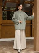 Chulan stand-collar coat styled with cream wide-leg trousers and silver shoes