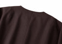 Close-up of the cocoa-brown jacket’s back neckline and center seam
