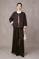 Front view of the model wearing the snap-front cocoa jacket closed