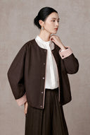 Side view showing the jacket’s roomy sleeve and pink cuff