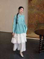 Full look of the cooling blue mulberry silk Hualuo shirt styled with a white lace skirt and silver shoes