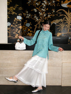 Cooling blue Hualuo silk shirt styled with a white layered skirt and Chinese-inspired accessories