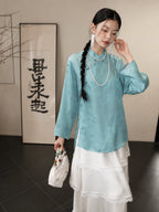 Model wearing a cooling blue 100% mulberry silk Hualuo Mandarin collar shirt with a white layered skirt