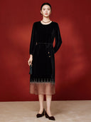 Full front view of the black velvet midi dress with gathered sleeves and a geometric embellished hem