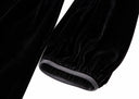 Close-up of the gathered black velvet sleeve and contrasting cuff trim