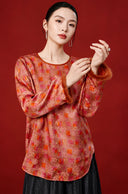 Model showing the coral pink blouse’s brown textured cuffs, orange colour blocks and floral outlines.