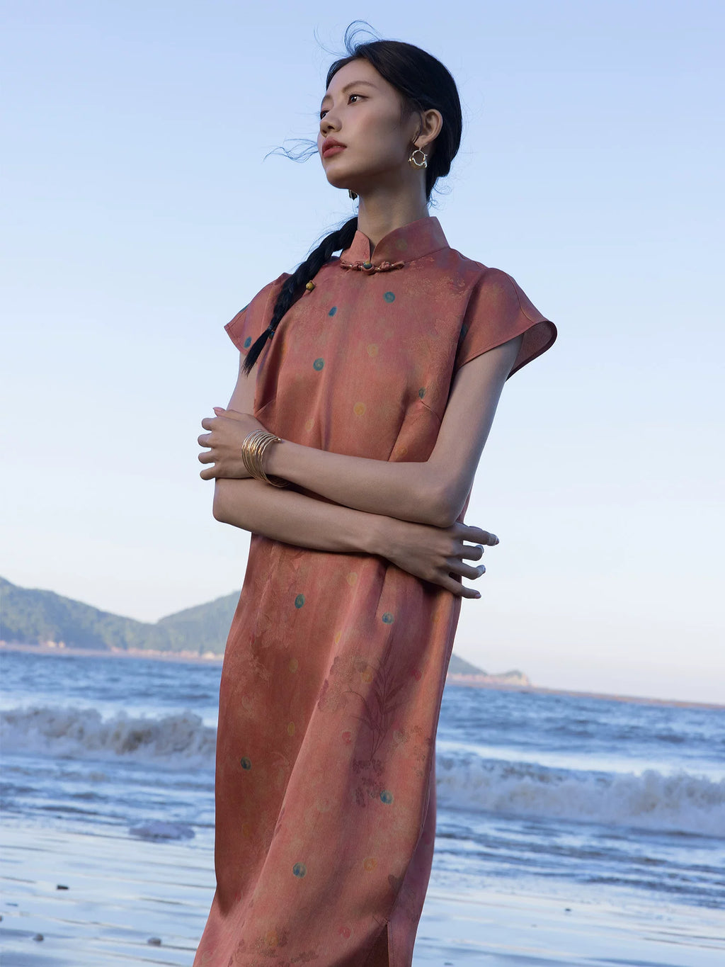 Close-up of a Chinese style silk blend dress in Coral Sunset with woven floral texture and mandarin collar.