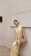 Front view of a sleeveless Cheongsam co-ord set in cream yellow, with button-down front and wide-leg trousers.