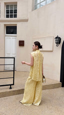 Back view of a cream Cheongsam set with invisible zipper on the top, showcasing the drape of the viscose blend wide-leg pants.