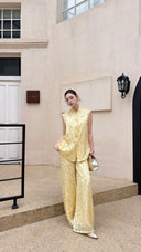 Front view of a mandarin collar Cheongsam set in cream yellow, with tonal jacquard texture and an elegant silhouette.