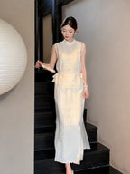 Model walking down stairs in a cream white A-line midi skirt and matching vest, showcasing the scalloped hem and side tie details.