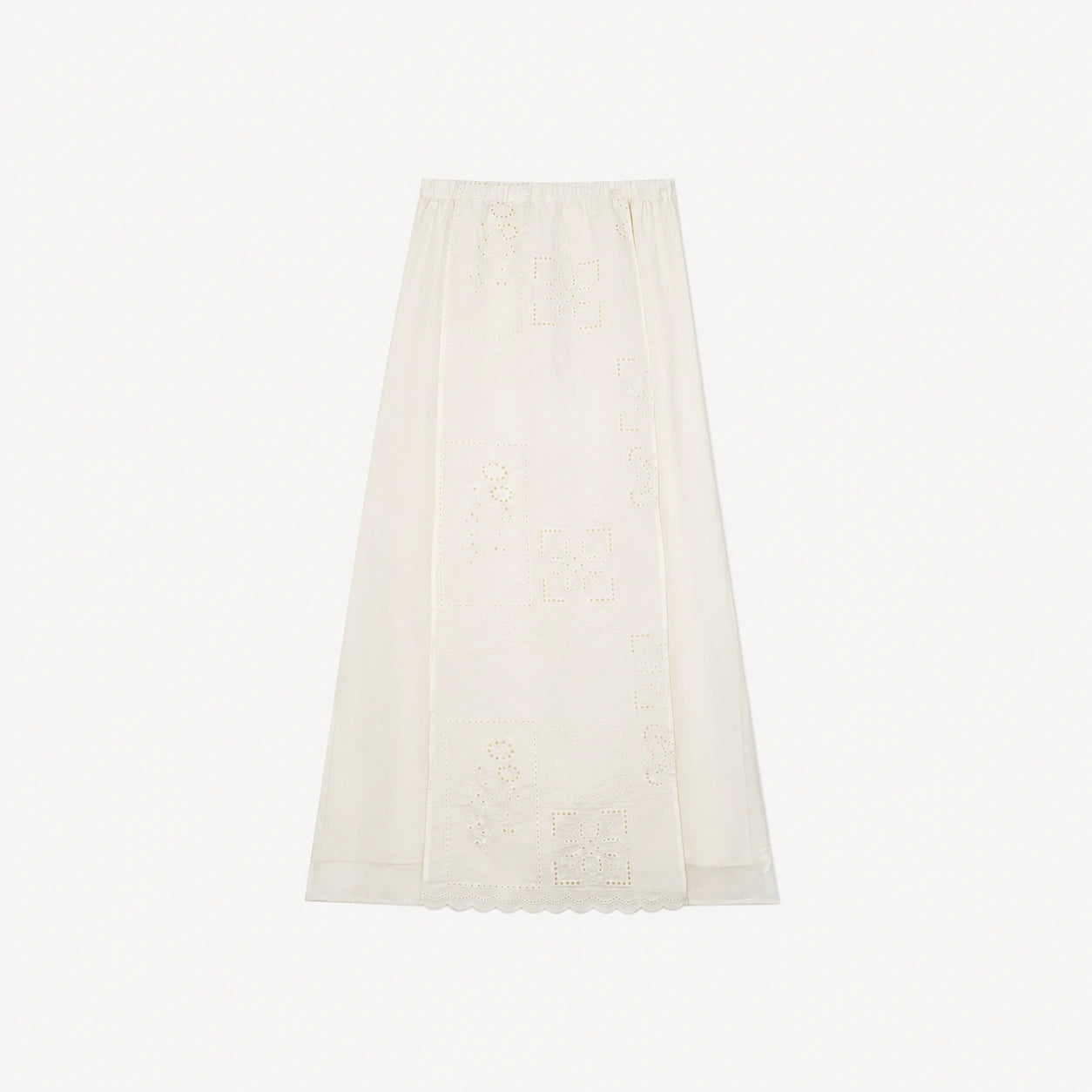 Flat lay of a cream white midi skirt with geometric embroidery and a scalloped hem, featuring an elastic waistband.