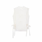 Flat lay of a cream white sleeveless Cheongsam vest with geometric embroidery, side ties, and a front button closure.