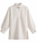 Front view of the Ningzhi Ivory shirt showing its textured surface, stand collar and side slits.