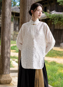 Model wearing the Ningzhi Ivory shirt, showing its relaxed fit and curved front hem.