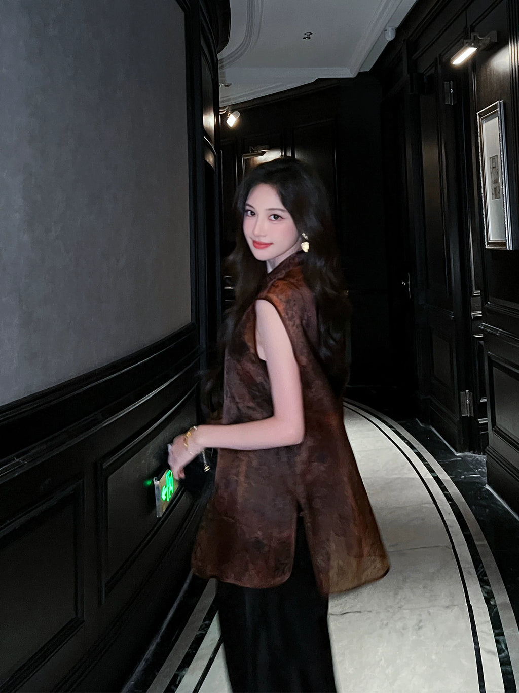 Back side view of a woman wearing a Dark Walnut Brown Mulberry Silk jacquard sleeveless vest.