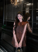 Woman wearing a Dark Walnut Brown jacquard Mulberry Silk sleeveless vest styled with a flowing black skirt.