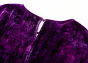 Close-up of the purple velvet dress’s back neckline opening and button-and-loop fastening.