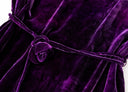 Close-up of the matching purple velvet cord waist tie with its fabric flower detail.