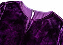 Close-up of the purple velvet dress’s V-shaped front keyhole and narrow strap across the neckline.