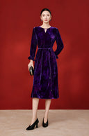 Full-length outfit featuring the deep purple velvet midi dress, black heels and a black clutch.