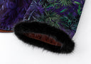 Close-up of black textured trim around the purple blouse’s printed sleeve opening.