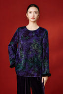 Front view of the purple foliage-print blouse on a model, showing its relaxed cut and round neckline.