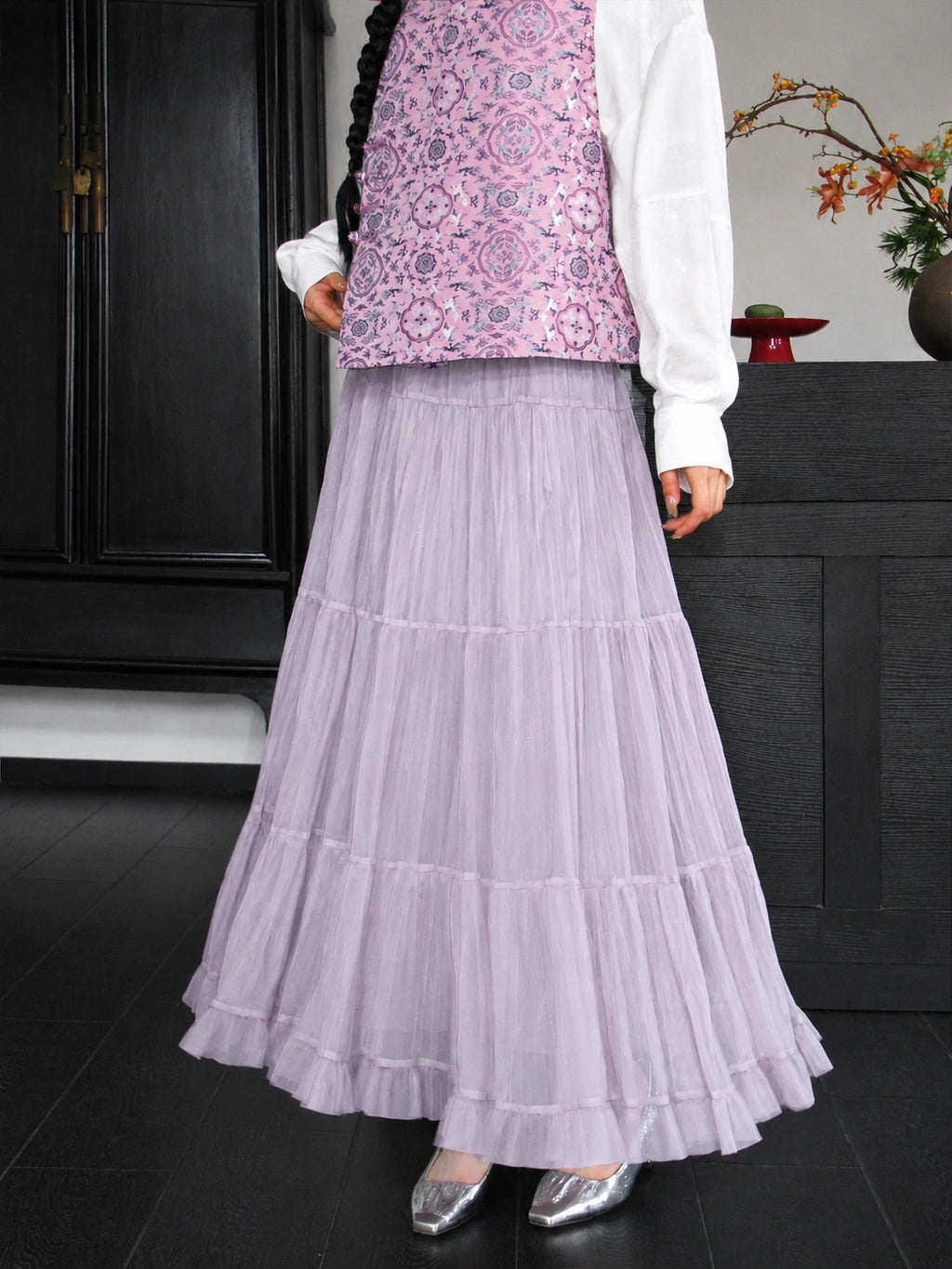 Close-up of the dusty lavender silk vest with an intricate repeating Bao Xiang floral pattern.