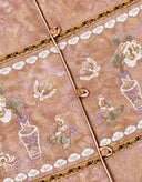 Close-up of the vest’s floral-and-vase motif, patterned trim and front buttons.